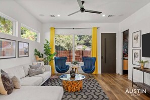 Living room with large smart tv and plenty of seating