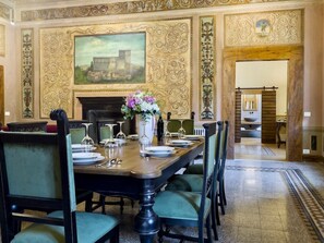 The grand parlour features a custom dining room table with seating for eight.