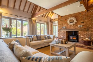The Cart Shed, North Creake: Sitting room with wood-burning stove
