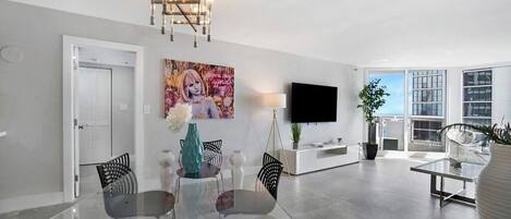 Dining/living area, Roku tv, balcony access, view into master bedroom