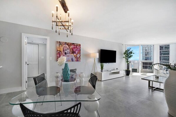 Dining/living area, Roku tv, balcony access, view into master bedroom