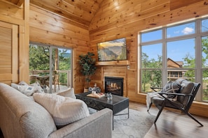 Relax by the fireplace after a day of exploring the top local attractions in Gatlinburg, Pigeon Forge, and Townsend | Elkridge Cabin by Great Smoky Mountains Cabin Rentals | Sevierville, TN