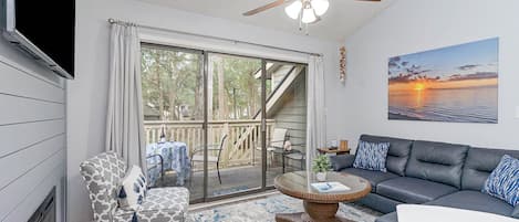 Living Room - Seating area with electric fireplace opens to a deck.