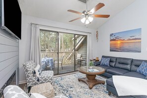 Living Room - Seating area with electric fireplace opens to a deck.