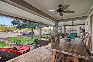 This waterfront home has an oversized patio & an upper deck for outdoor dining.