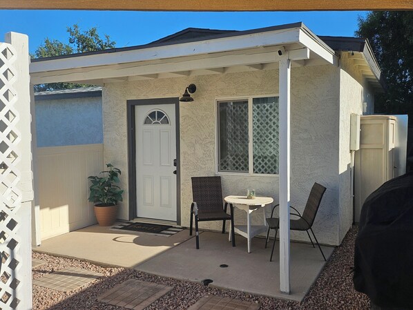 Charming detached home with a white front door and a covered porch area