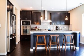 Modern kitchen with sleek countertops, ample cabinetry, and stainless steel appliances—designed for both everyday cooking and effortless entertaining.