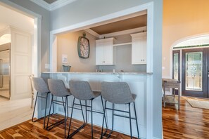 Wet bar with ice maker, sink and beverage refrigerator.