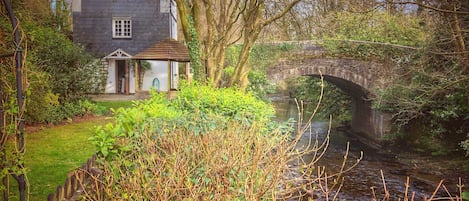 View of the cottage and bridge from the back garden.