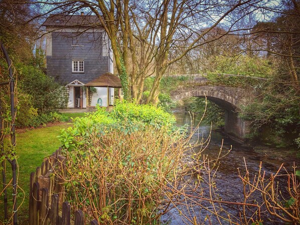 View of the cottage and bridge from the back garden.