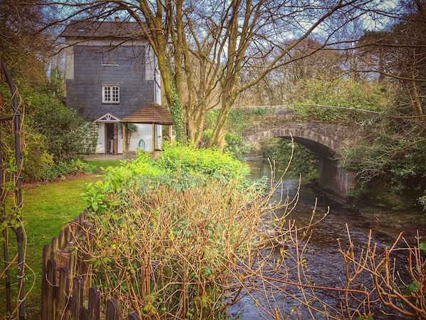 View of the cottage and bridge from the back garden.