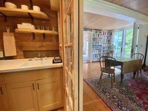 Sliding salvaged glass doors can be closed going into the kitchenette.