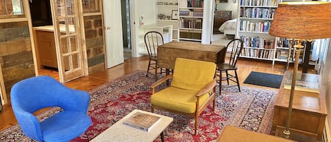 Mid-century furniture, books galore, and a quaint farmhouse kitchenette.