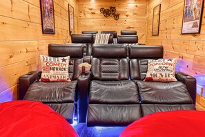 Home theater with reclining leather seats and oversized bean bags that the kids, or the kids at heart, will love!