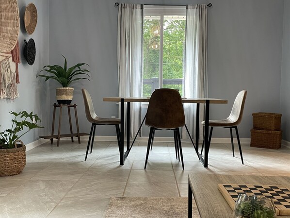 Dining table overlooks the large front porch and wooded view. 