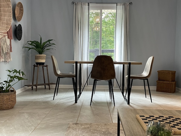 Dining table overlooks the large front porch and wooded view. 