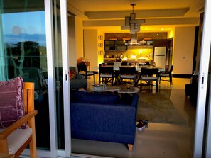 view from deck through living room to dining area and kitchen