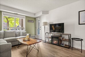 Living room with electric fireplace & pull-out bed