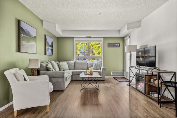 Living room with electric fireplace & pull-out bed