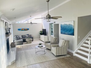 Open living room. Stairs lead up to Master Bedroom.  Sliding doors open to deck 