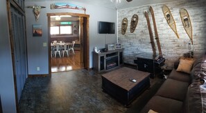 Entry room with queen sofa sleeper, flat screen TV and privacy barn doors. 