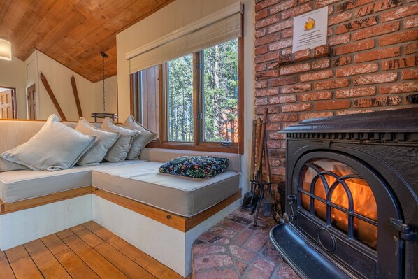 A custom made seating area with storage next to the fire.