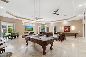 Massive game room with shuffleboard, pool table, fireplace and 85" HD TV