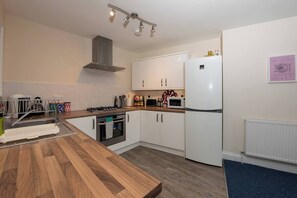 Kitchen: Modern amenities abound in this well-equipped kitchen, perfect for culinary adventures!