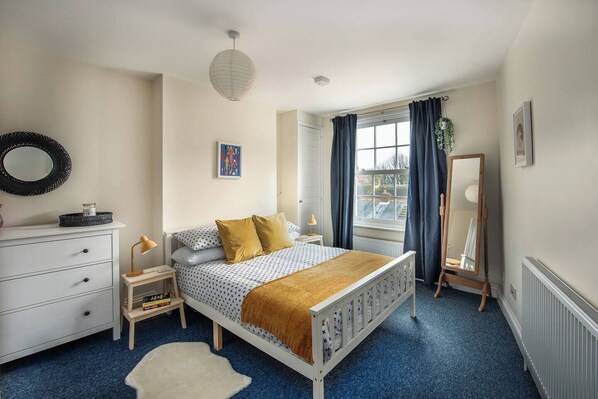 Bedroom: Bright and airy retreat with charming decor and lovely city views awaits your stay!
