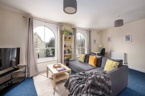 Living Room: Bright and airy space with stunning views, plush seating, and playful decor for relaxation!