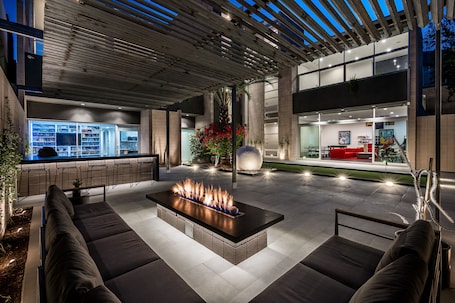 Modern Arizona retreat, The George, with a stunning outdoor lounge, cozy fire pit, and sleek open design. Perfect for evenings under the stars