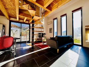 living room, dining room and the staircase leading to the mezzanine