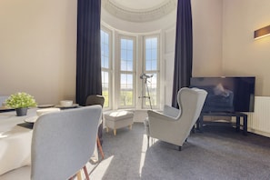 A closer look at the tall bay windows, complete with a lovely comfy armchair!