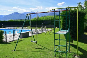 The green fields around the property, equipped for children