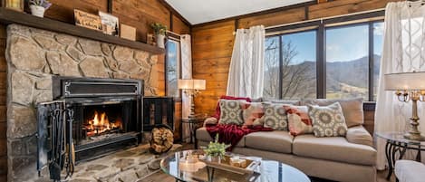 Cozy living room with fire place and mountain view