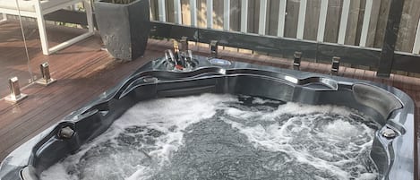 Outdoor patio in-ground hot tub.