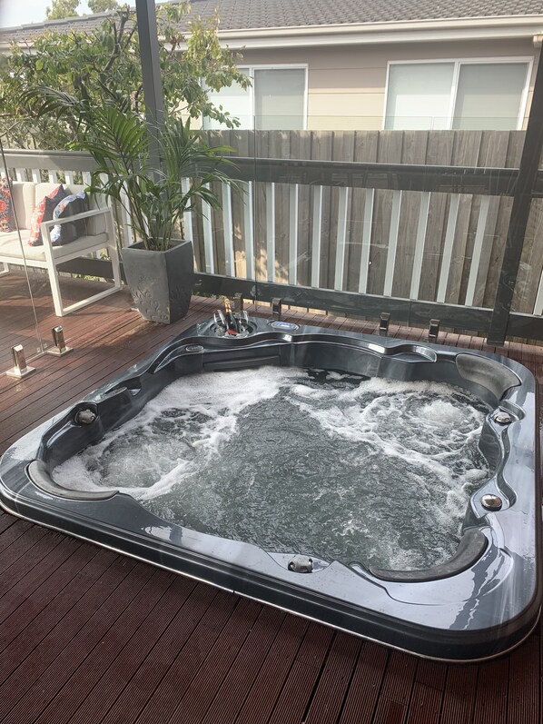 Outdoor patio in-ground hot tub.