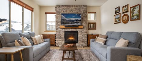 Enjoy a cozy living room with new couches, gas fireplace and smart tv.