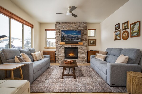 Enjoy a cozy living room with new couches, gas fireplace and smart tv.