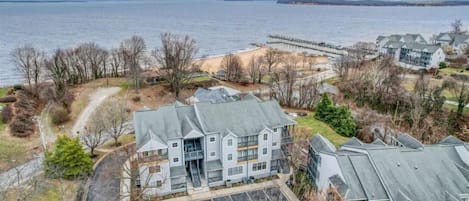 Aerial view of condo, beach and bay.