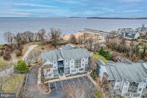 Aerial view of condo, beach and bay.