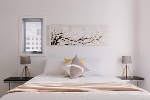Retreat to the first bedroom featuring a king koil executive extra-long mattress and built-in wardrobes.