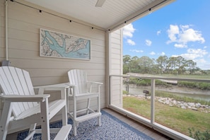 Watch the marsh, tide, wildlife, and sunsets without leaving the screened-in patio.