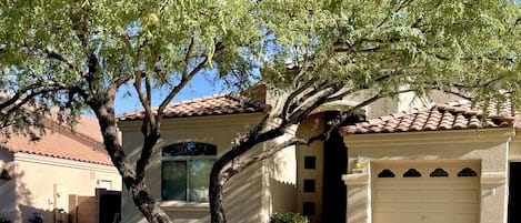 The entrance to the house and view of one of the garage doors