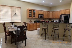 View of the kitchen with a kitchen table and island for eating. Granite counters