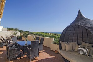 Terrace with dining table and beach chair