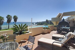 Two sun loungers on the terrace overlooking the pool