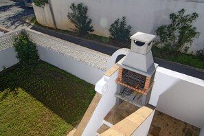 Outdoor barbecue on the stairs between terrace and garden