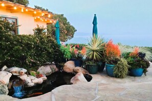 Enjoy the sounds of the waterfall in the koi pond near your private deck beyond.