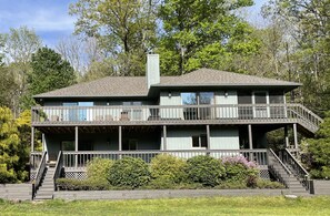 Photo of home from Rear lake - multiple decks with plenty of outdoor seating 
